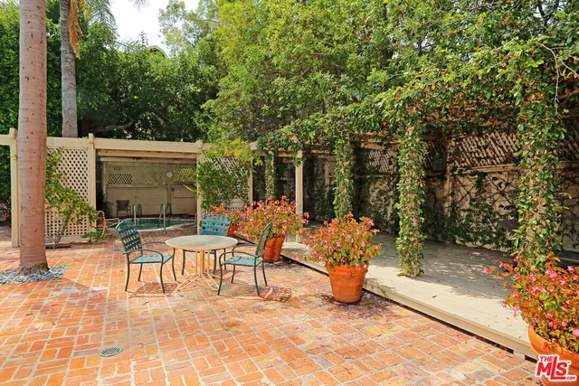 a view of a patio with table and chairs and potted plants