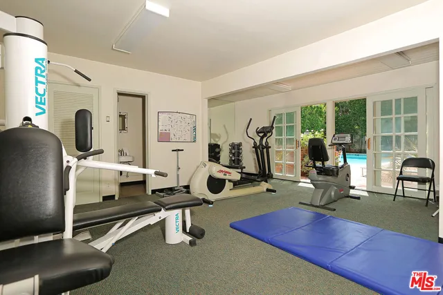 a room with gym equipment and a large window