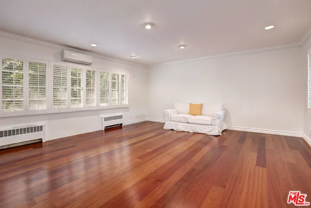 a living room with couch and a wooden floor