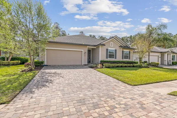 a front view of a house with a yard and garage