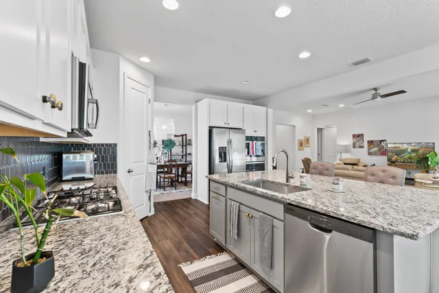 a kitchen with sink stove and cabinets