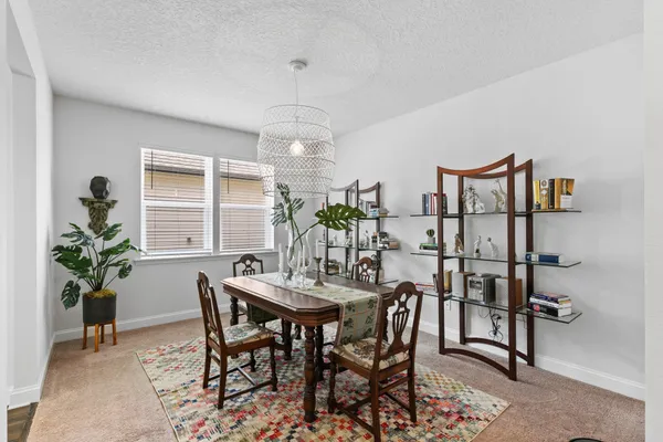 a view of a dining room with furniture and a potted plant