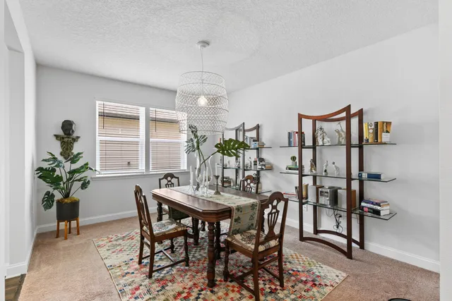 a view of a dining room with furniture and a potted plant
