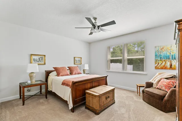 a bedroom with a bed and a couch next to a window