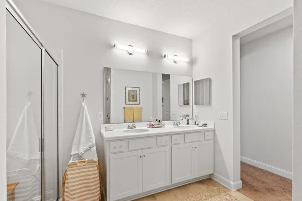 a spacious bathroom with a double vanity sink and a mirror