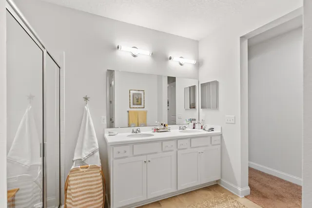a spacious bathroom with a double vanity sink and a mirror