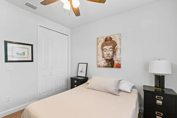 a bedroom with a bed and a lamp on a table