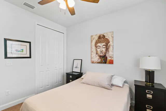 a bedroom with a bed and a lamp on a table