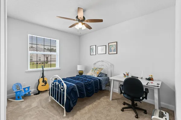 a bedroom with bed and a window
