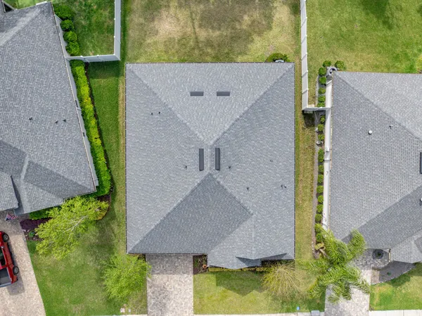 a aerial view of a house with a garden and lake view