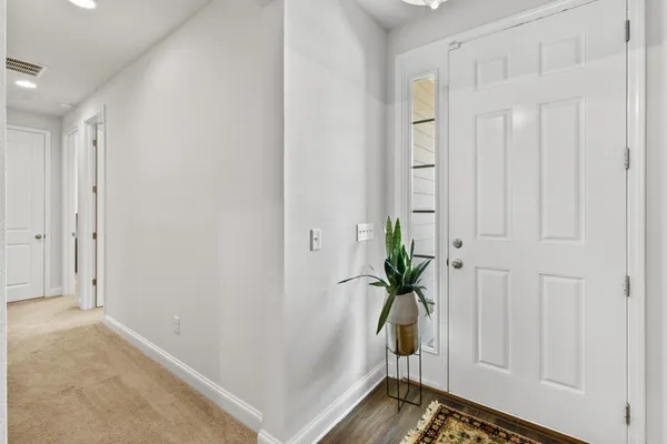 a view of entryway with wooden floor