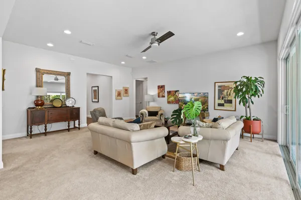 a living room with furniture and a potted plant