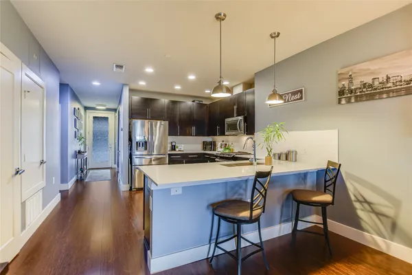 a large kitchen with stainless steel appliances kitchen island a large island in the center