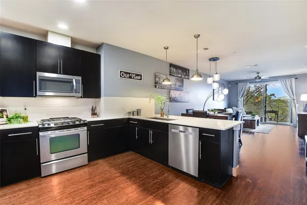 a kitchen with stainless steel appliances granite countertop a stove and a sink