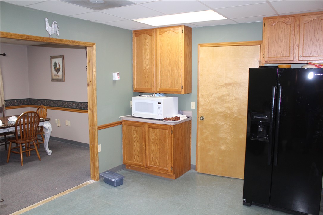 158 Ragon Road Tilly, AR 72679 - Photo 12 of 51 Kitchenette featuring wood-finish cabinetry and a black refrigerator