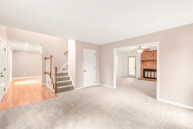 an empty room with a window and wooden floor