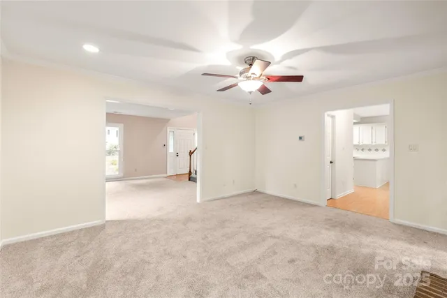 a view of an empty room with window and a fireplace