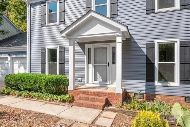 a view of a house with potted plants