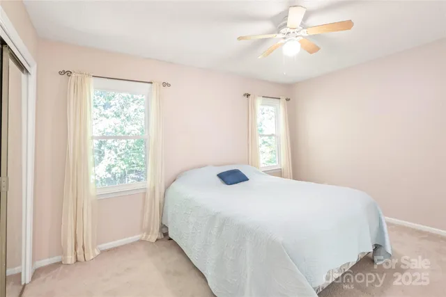 a bedroom with a bed and a ceiling fan