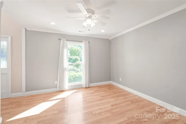 an empty room with windows and closet