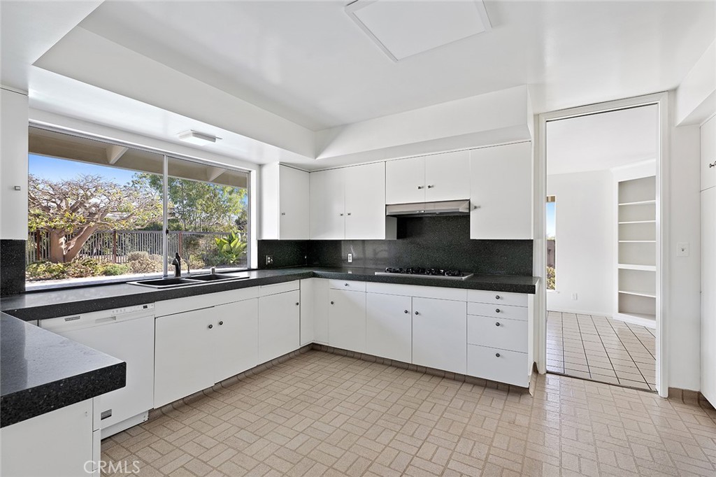 23 Monarch Bay Drive Dana Point, CA 92629 - Photo 13 of 45 a kitchen with granite countertop a stove a sink and a refrigerator
