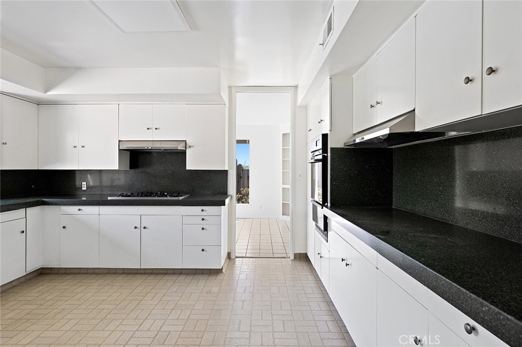 23 Monarch Bay Drive Dana Point, CA 92629 - Photo 14 of 45 a large kitchen with cabinets stove and microwave