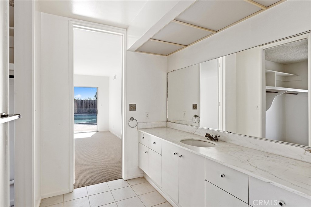 23 Monarch Bay Drive Dana Point, CA 92629 - Photo 24 of 45 a bathroom with a double vanity sink and a mirror