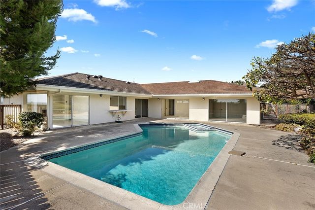a view of a house with a yard and sitting area