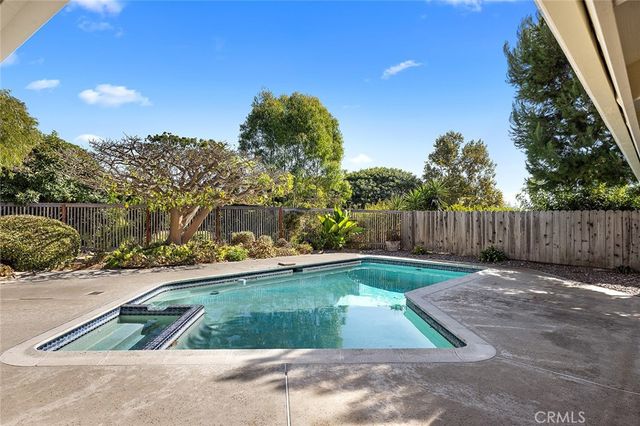 a view of backyard with wooden fence