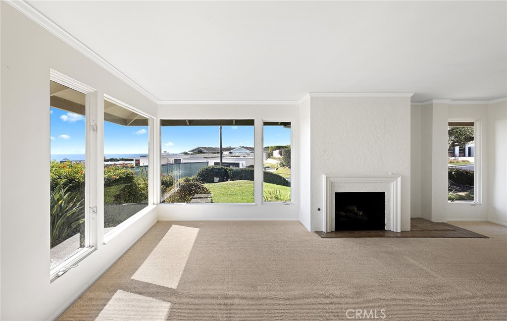 23 Monarch Bay Drive Dana Point, CA 92629 - Photo 10 of 45 a view of a livingroom with a fireplace and window