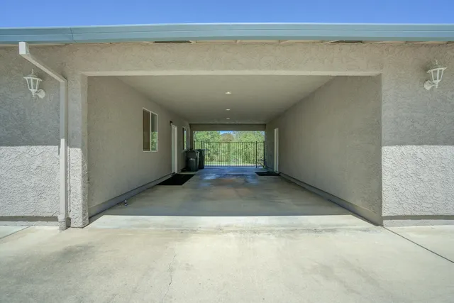 a view of a house with a yard and large tree