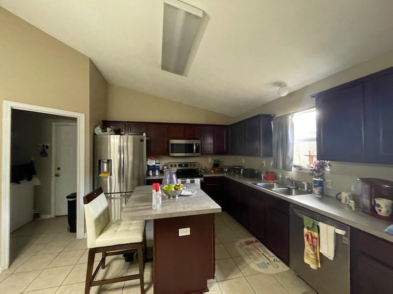 204 Limestone Circle Crestview, FL 32539 - Photo 11 of 19 a kitchen with sink refrigerator and cabinets