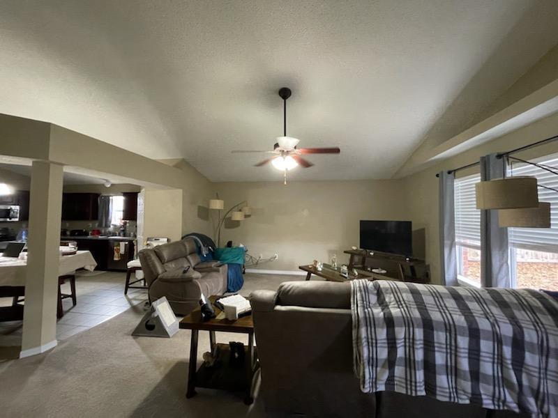 204 Limestone Circle Crestview, FL 32539 - Photo 4 of 19 a living room with furniture a flat screen tv and kitchen view