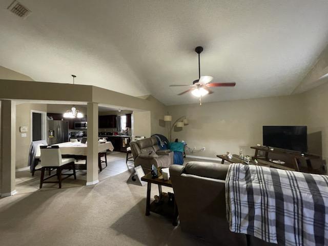 204 Limestone Circle Crestview, FL 32539 - Photo 5 of 19 a living room with furniture a chandelier and a flat screen tv