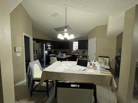 204 Limestone Circle Crestview, FL 32539 - Photo 6 of 19 a view of a dining room with furniture and a chandelier