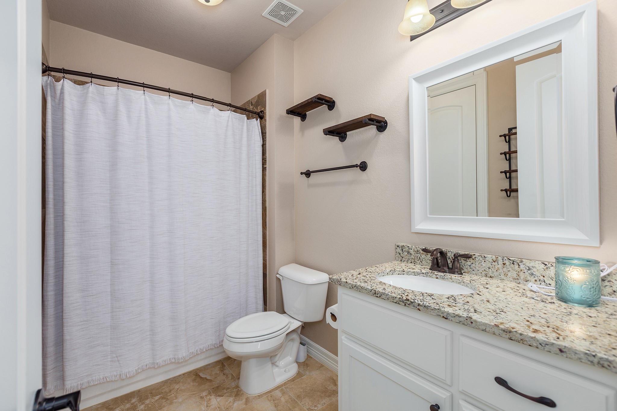 27688 Rio Blanco Drive Splendora, TX 77372 - Photo 31 of 50 a bathroom with a granite countertop sink toilet and shower