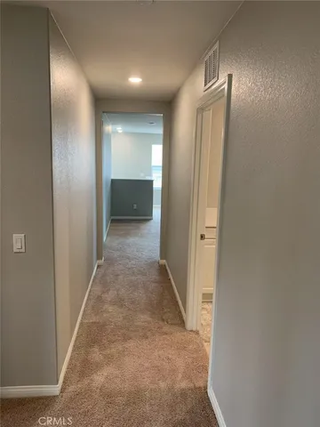 an empty room with closet and a bathroom