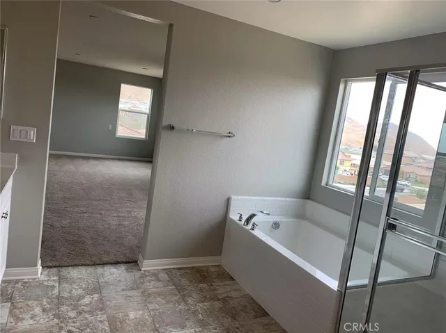 a bathroom with a bathtub and shower