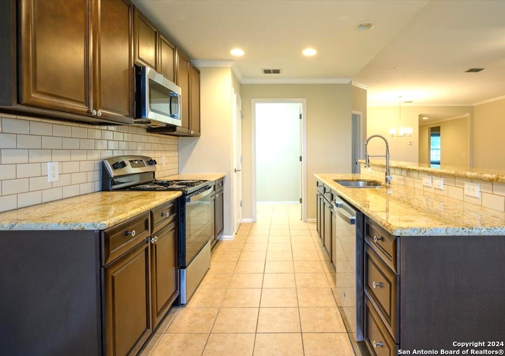 1370 Tractor Pass Schertz, TX 78154 - Photo 2 of 16 a kitchen with stainless steel appliances granite countertop a sink stove and cabinets