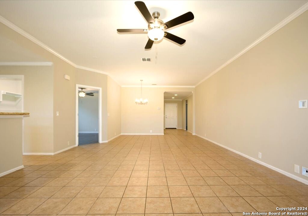 1370 Tractor Pass Schertz, TX 78154 - Photo 4 of 16 a view of an empty room and a ceiling fan & kitchen view