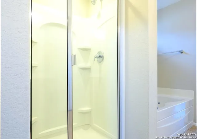 a bathroom with a glass shower door
