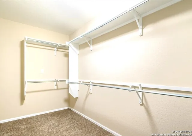 a view of a room with racks on the wall and a window