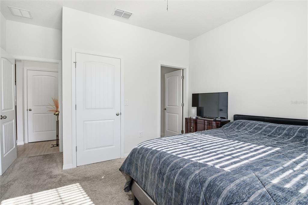 16098 Mangrove Road Winter Garden, FL 34787 - Photo 11 of 40 a bedroom with a bed and a flat screen tv