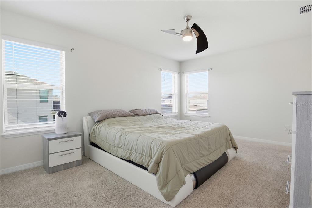 16098 Mangrove Road Winter Garden, FL 34787 - Photo 19 of 40 a bedroom with a bed next to a window