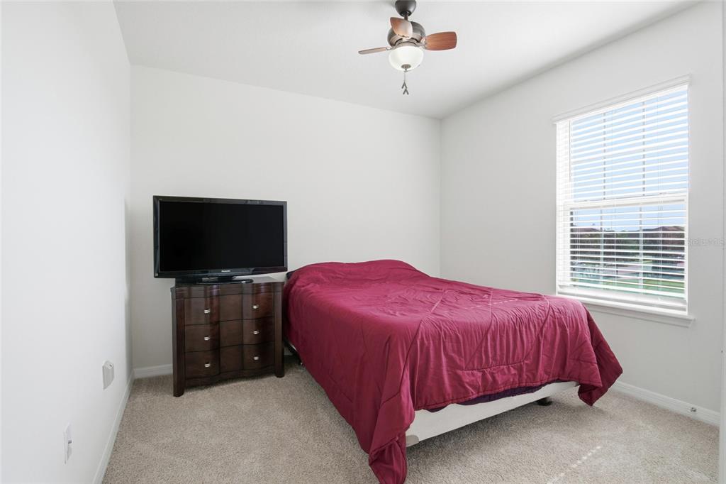 16098 Mangrove Road Winter Garden, FL 34787 - Photo 24 of 40 a bedroom with a bed and a flat screen tv