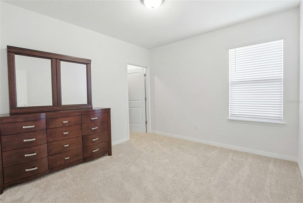 16098 Mangrove Road Winter Garden, FL 34787 - Photo 26 of 40 a room with a bed and a dresser in it