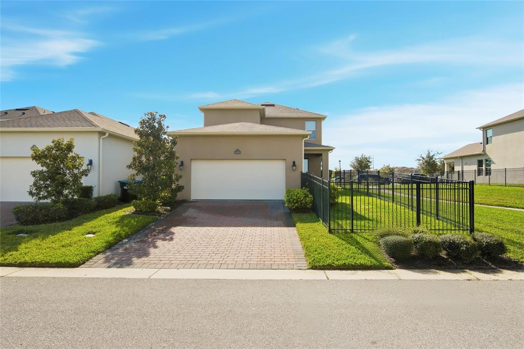 16098 Mangrove Road Winter Garden, FL 34787 - Photo 31 of 40 a front view of a house with a garden and trees