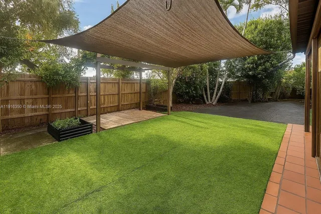 a view of a backyard with a sitting area