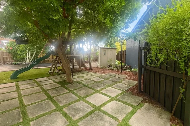 a view of a street with large trees