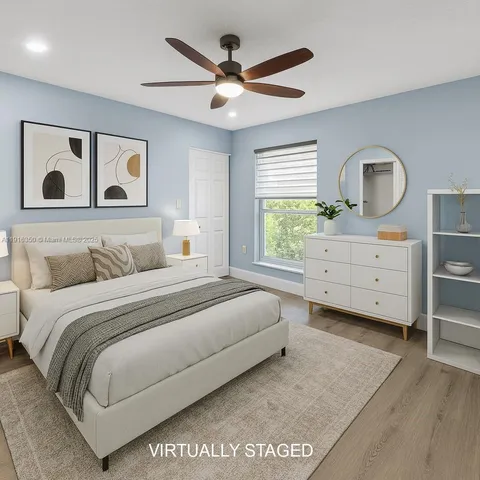 a bedroom with a large bed and a window